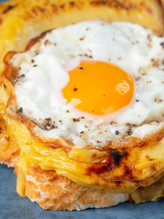 Fried egg served on top of Welsh rarebit or British cheese on toast aka buck rarebit.