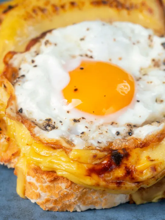 Fried egg served on top of Welsh rarebit or British cheese on toast aka buck rarebit.