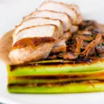 Sliced chicken breast forestiere or mushrooms in a creamy brandy sauce.