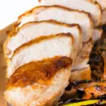 Close-up sliced chicken breast forestiere or mushrooms in a creamy brandy sauce.