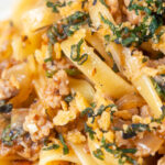 Close up minced chicken and sage pasta with sweet caramelised onions and sage crumb.