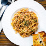 Overhead chicken and sage pasta with sweet onions and sage crumb.