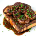 Classic British devilled lambs kidneys on toast with snipped chives.