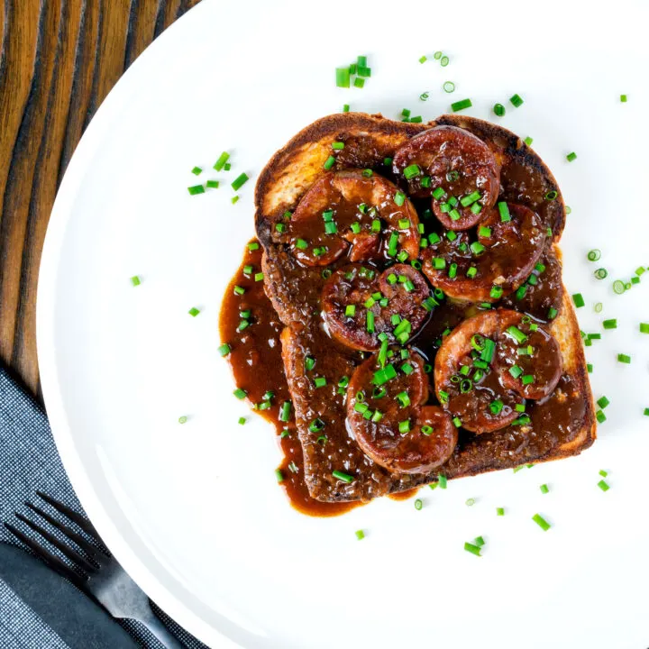 British devilled kidneys on toast in a rich sauce with snipped chives.