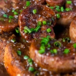 Close up classic British devilled lambs kidneys on toast with snipped chives.