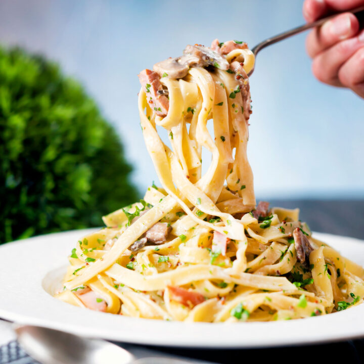 Creamy ham and mushroom tagliatelle pasta with wholegrain mustard and fresh parsley.