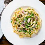 Overhead creamy ham and mushroom tagliatelle with a creme fraiche and mustard sauce.