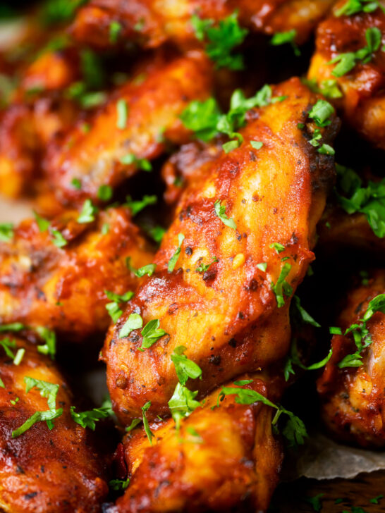 Close-up spicy, sweet and sour sticky date and harissa chicken wings.