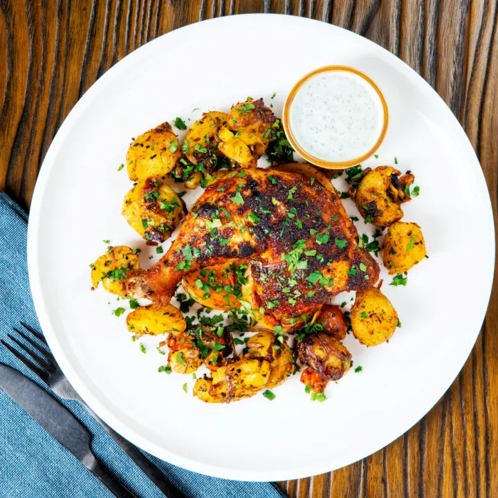 Indian spiced roast chicken legs served with roasted Bombay potatoes.