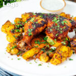 Easy roast chicken legs served with onion and Bombay roast potatoes featuring a title overlay.