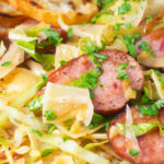 Close-up Polish pasta or lazanki with kielbasa sausage, cabbage and sauerkraut.