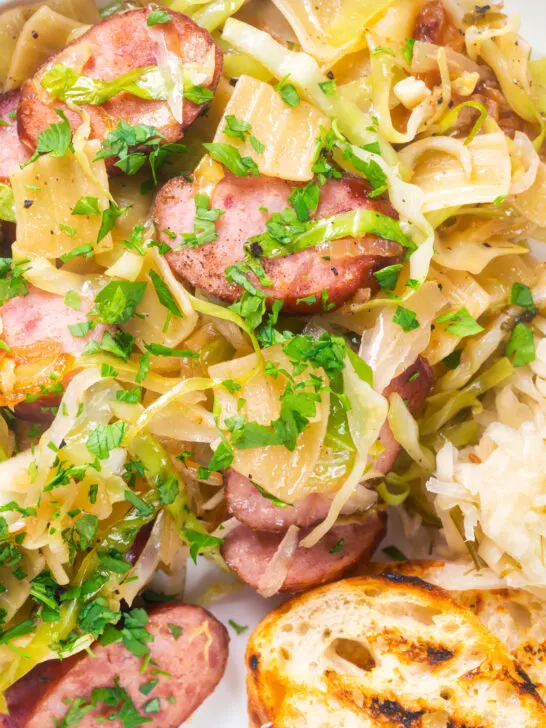 Overhead close-up Polish noodles or lazanki with kielbasa sausage, cabbage and sauerkraut.