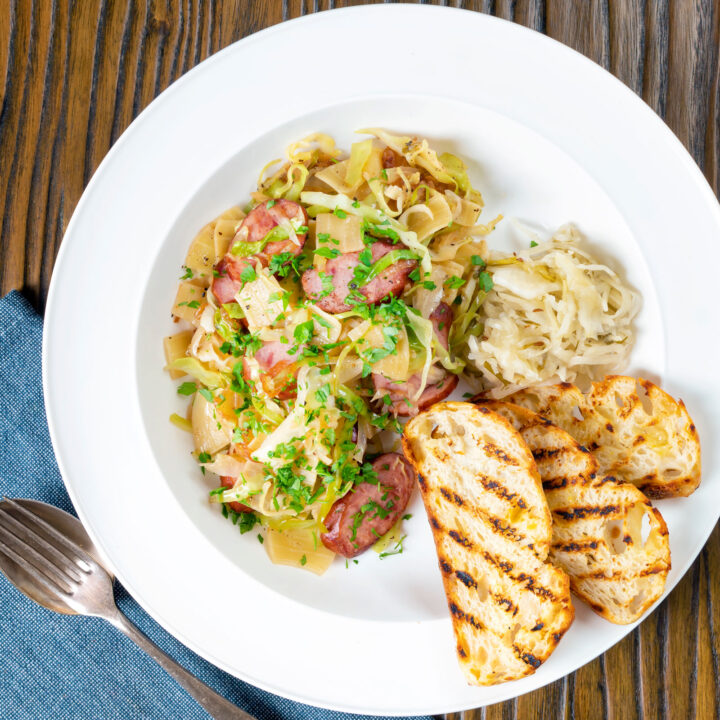 Polish lazanki pasta or noodles with cabbage, sauerkraut and smoked sausage.