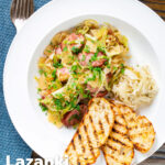 Overhead Polish noodles or lazanki with kielbasa sausage and cabbage served with bread and sauerkraut featuring a title overlay.