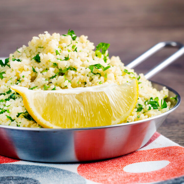 Plain buttered couscous with lots fresh herbs and a lemon wedge.