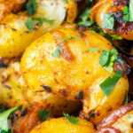 Close-up oven roast Bombay potatoes or Bombay aloo with fresh coriander.