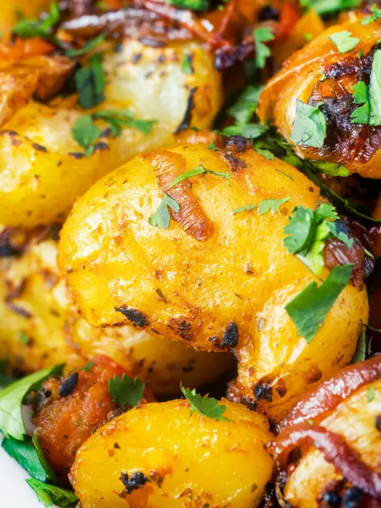 Close-up oven roast Bombay potatoes or Bombay aloo with fresh coriander.