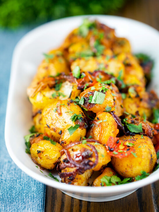 Oven roast Bombay potatoes or Bombay aloo with fresh coriander.