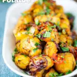 Oven roast Bombay potatoes or Bombay aloo with fresh coriander featuring a title overlay.
