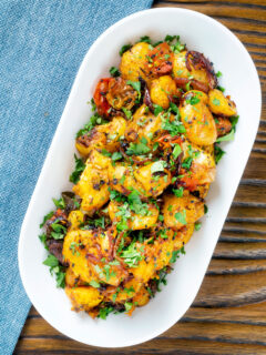 Overhead oven roast Bombay potatoes or Bombay aloo with fresh coriander.