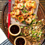 Overhead salt and pepper prawns with a chilli dipping sauce and soba noodle salad.