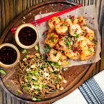 Salt and pepper prawns with a spicy dipping sauce served with a soba noodle salad.