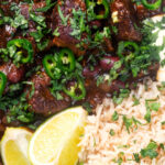 Overhead close-up chunky beef chilli con carne cooked in a slow cooker served with brown rice.