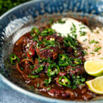 Chunky beef chilli con carne cooked in a slow cooker served with brown rice.