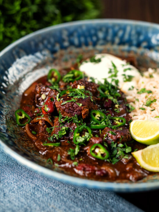 Chunky beef chilli con carne cooked in a slow cooker served with brown rice.