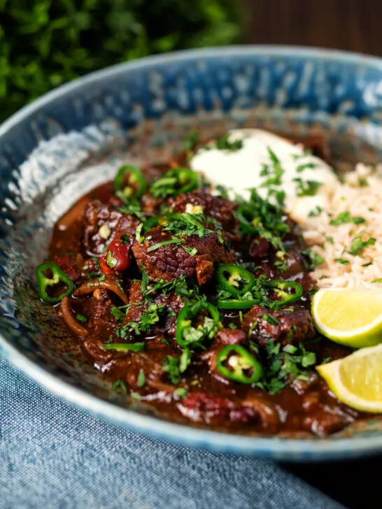 Chunky beef chilli con carne cooked in a slow cooker served with brown rice.