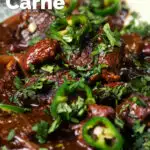 Close-up chunky beef chilli con carne cooked in a slow cooker served with brown rice featuring a title overlay.