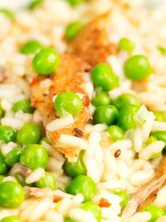 Close up smoky mackerel and garden pea risotto with chilli flakes.