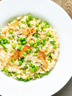 Overhead smoked mackerel risotto with sweet peas and chilli flakes.