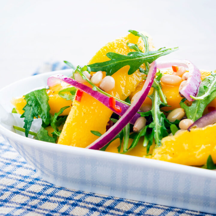 Sweet, sour and spicy chilli mango salad with red onion, pine nuts and rocket.