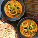 Overhead Indian-influenced squid ring curry in a coconut sauce.