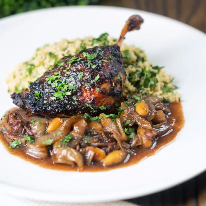 Slow roasted honey and tamarind glazed duck legs with onions, dates, almonds and couscous.