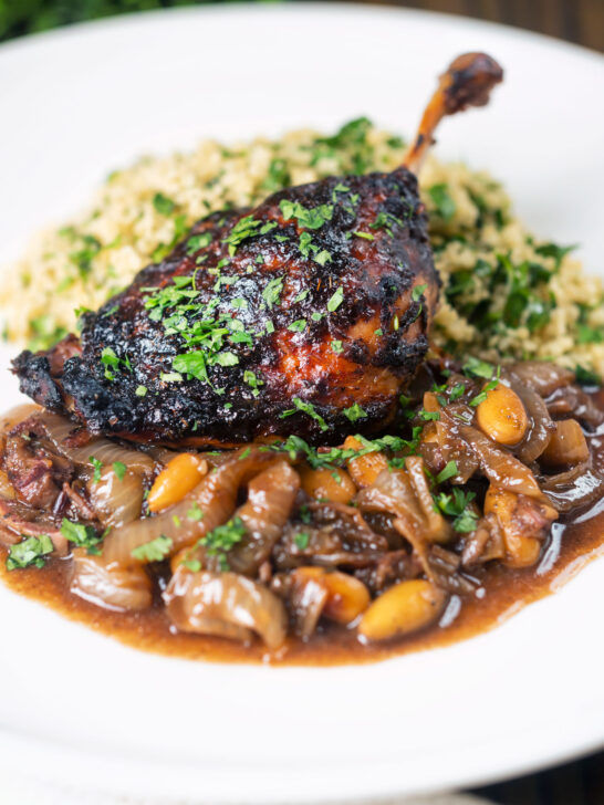 Tamarind and honey glazed duck leg with stewed onions, dates, almonds and buttered couscous.