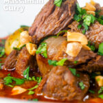 Close-up Spicy Thai beef massaman curry showing the texture of the cooked beef featuring a title overlay.