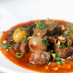 Spicy Thai beef massaman curry with potatoes, shallots and peanuts.