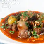 Spicy Thai beef massaman curry with potatoes, shallots and peanuts featuring a title overlay.