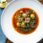 Overhead spicy Thai beef massaman curry with potatoes, shallots and peanuts.
