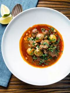 Overhead spicy Thai beef massaman curry with potatoes, shallots and peanuts.