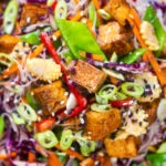 Overhead close-up crispy soy sauce tofu and rice vermicelli noodle and vegetable noodle salad.