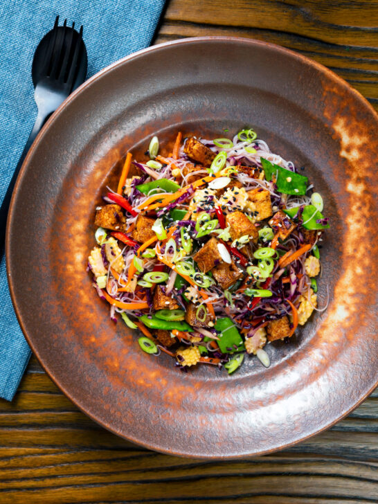 Overhead soy sauce tofu and rice vermicelli noodle salad with lots of veggies.