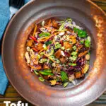 Overhead soy sauce tofu and rice vermicelli noodle salad with lots of veggies featuring a title overlay.