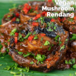 Close-up vegan mushroom rendang curry with coconut milk featuring a title overlay.