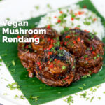 Vegan mushroom rendang curry with coconut milk featuring a title overlay.