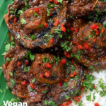 Overhead close up vegan mushroom rendang curry with coconut milk served on banana leaf featuring a title overlay.