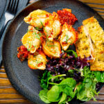 Baked stuffed pasta shells with goat's cheese and nduja in a tomato sauce with garlic bread.