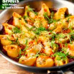 Skillet baked stuffed pasta shells with goat's cheese and nduja in a tomato sauce featuring a title overlay.